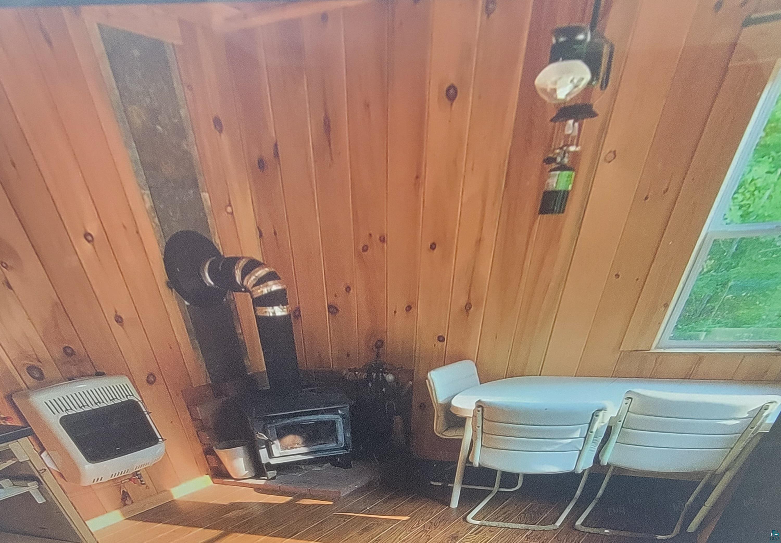 93355 Rowley Road Bayfield, WI 54814 - Photo 5 of 8 Details featuring a wood stove and wooden walls