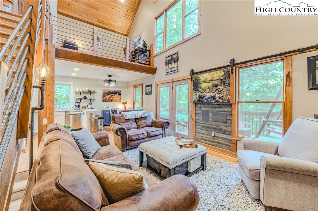 888 Benjamin Drive Boone, NC 28607 - Photo 11 of 38 a living room with furniture a rug and a large window