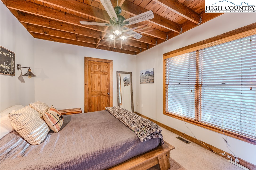 888 Benjamin Drive Boone, NC 28607 - Photo 18 of 38 a bedroom with a large bed and a large window
