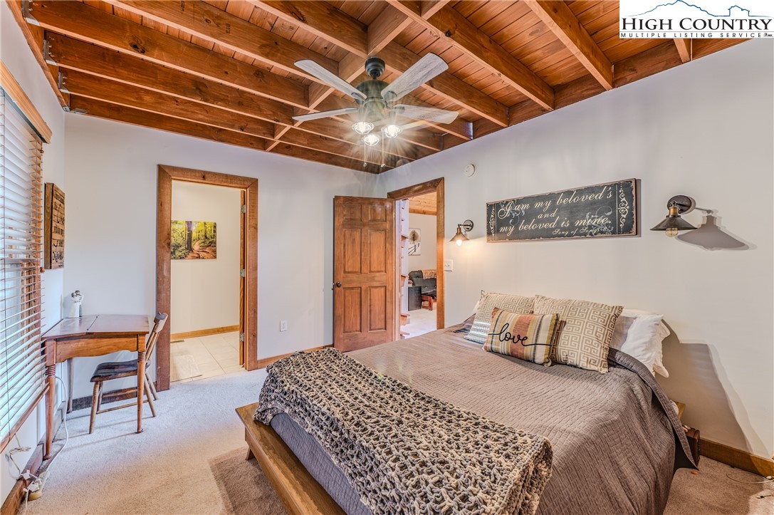 888 Benjamin Drive Boone, NC 28607 - Photo 19 of 38 a bedroom with a bed and a chandelier