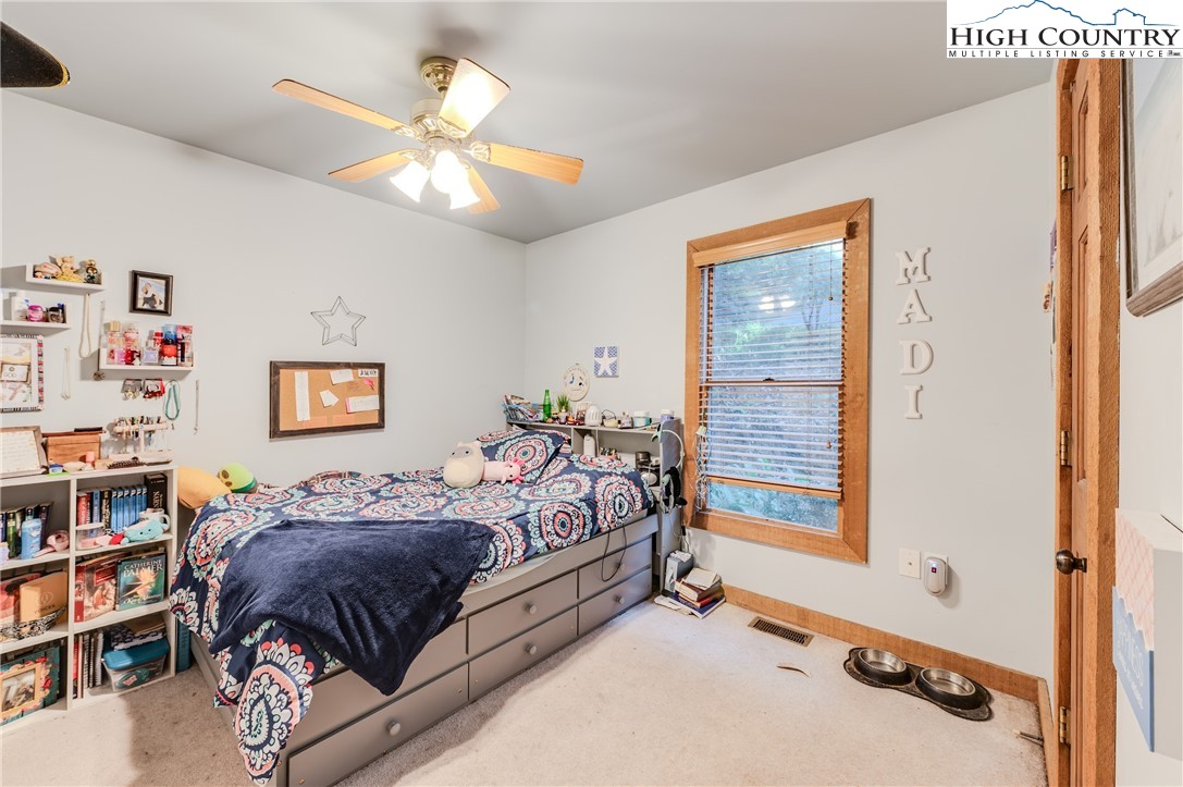 888 Benjamin Drive Boone, NC 28607 - Photo 22 of 38 a bedroom with a bed and a book shelf