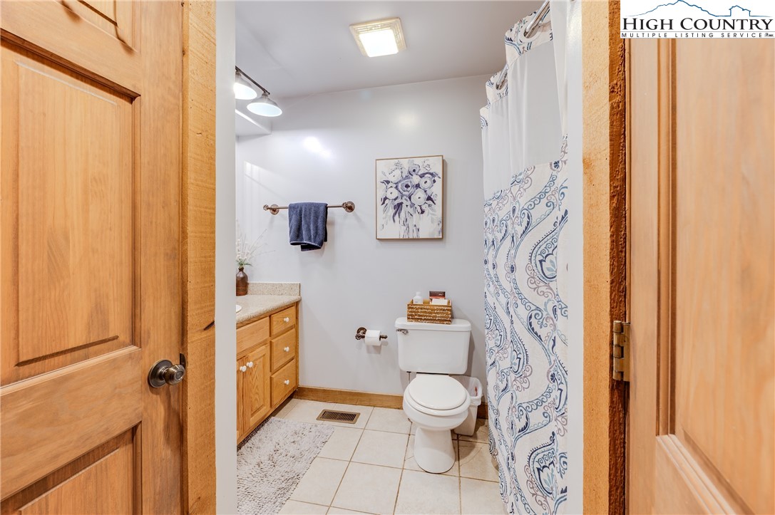 888 Benjamin Drive Boone, NC 28607 - Photo 24 of 38 a white toilet sitting next to a bathroom sink