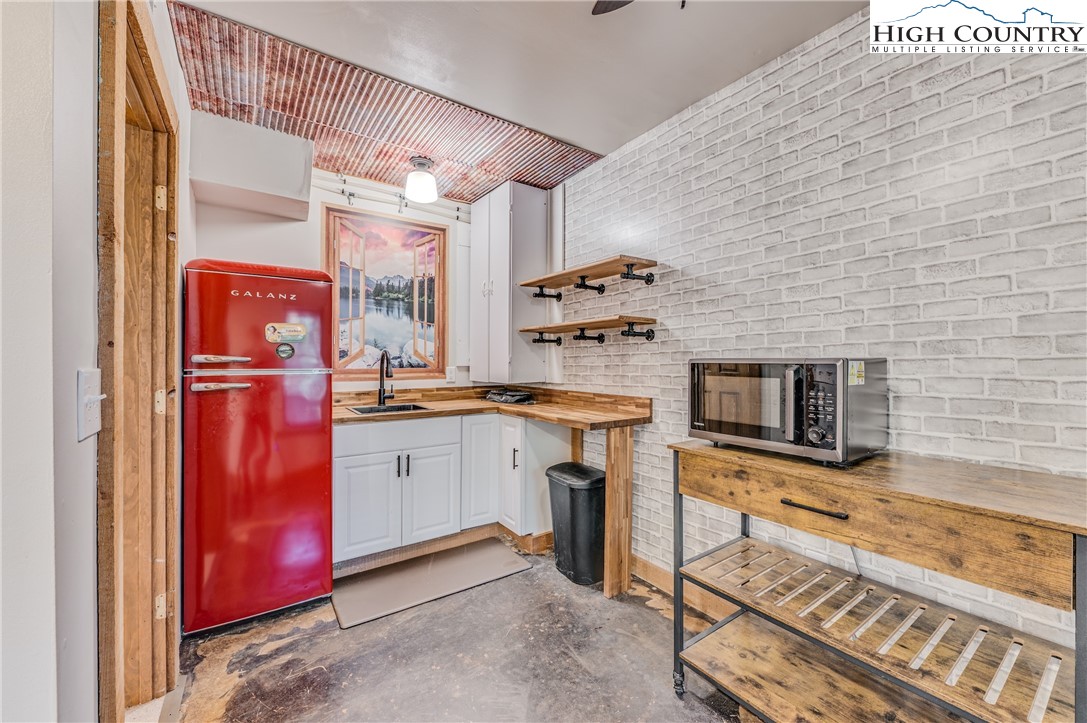 888 Benjamin Drive Boone, NC 28607 - Photo 28 of 38 a kitchen with stainless steel appliances granite countertop a stove top oven a sink and a microwave
