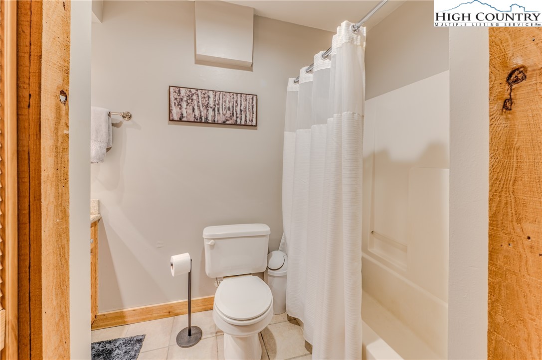 888 Benjamin Drive Boone, NC 28607 - Photo 30 of 38 a white toilet sitting next to a shower curtain