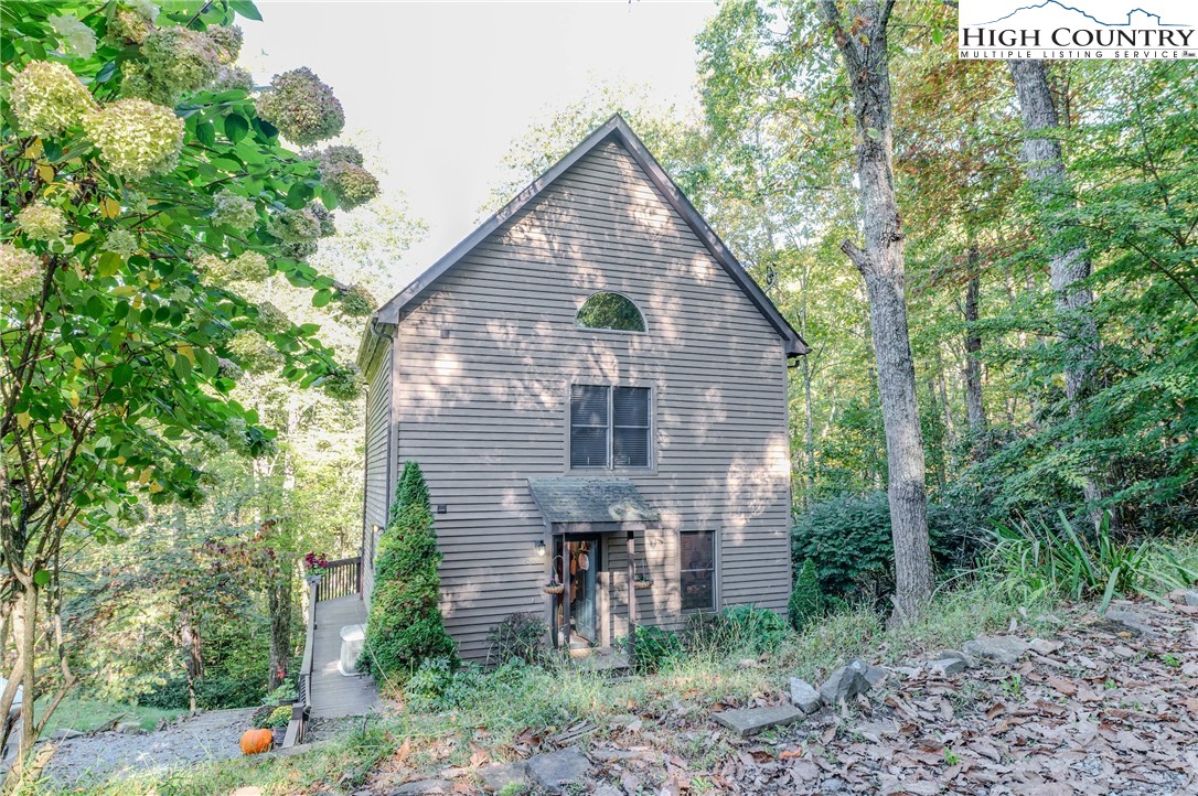 888 Benjamin Drive Boone, NC 28607 - Photo 3 of 38 a brick house with large windows and plants