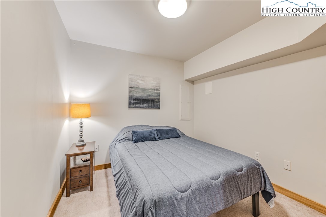 888 Benjamin Drive Boone, NC 28607 - Photo 32 of 38 a bedroom with a bed and a lamp