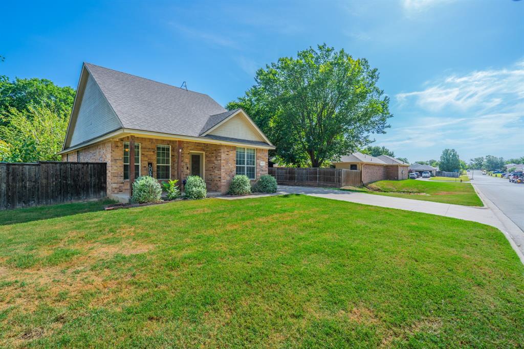 403 Summer Tree Lane Springtown, TX 76082 - Photo 15 of 19 Brick exterior with a dark shingle roof and a prominent front gable