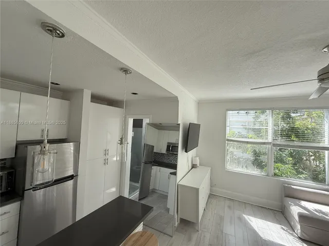 a kitchen with a refrigerator and a sink
