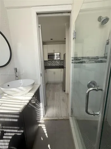 a bathroom with a granite countertop sink mirror and toilet