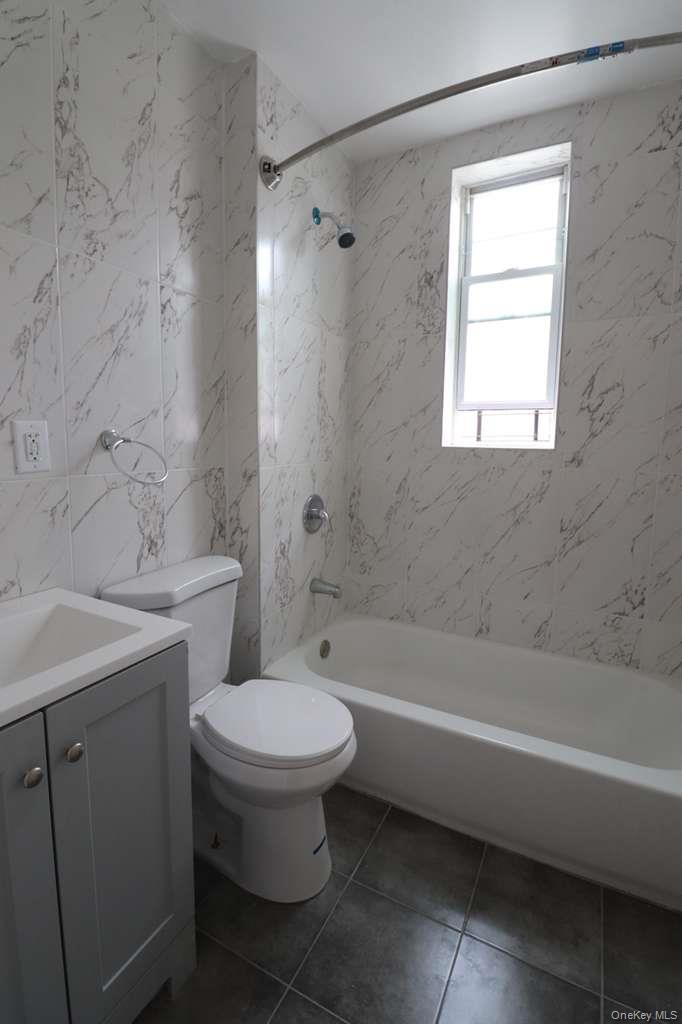 4432 Edson Avenue, Unit 1 Bronx, NY 10466 - Photo 3 of 4 a bathroom with a sink toilet and shower
