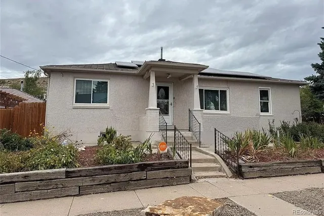 a front view of a house with garden