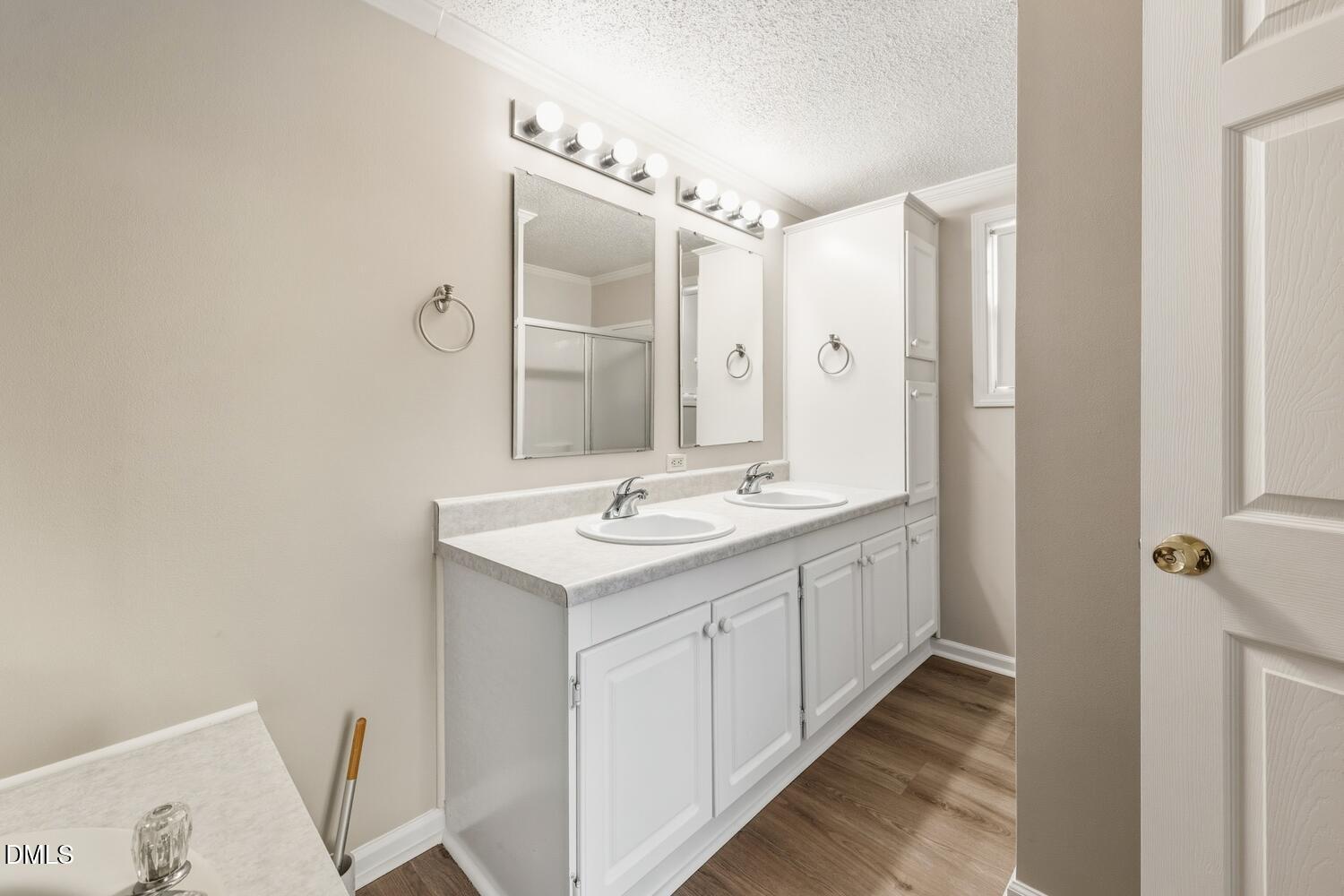7555 Babe Ruth Trail Snow Camp, NC 27349 - Photo 17 of 38 a bathroom with a double vanity sink and mirror