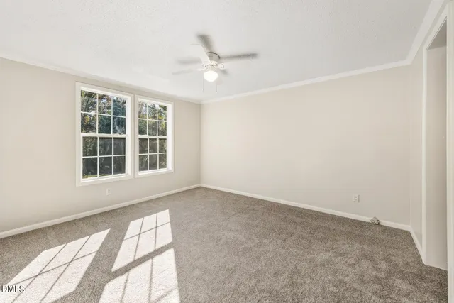 an empty room with windows and closet