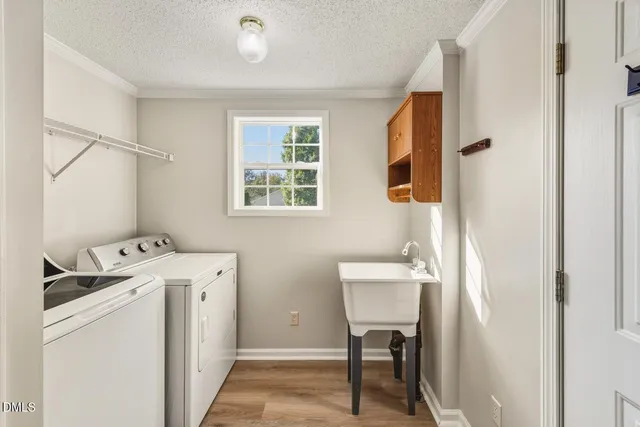 a room with a window and a washer dryer