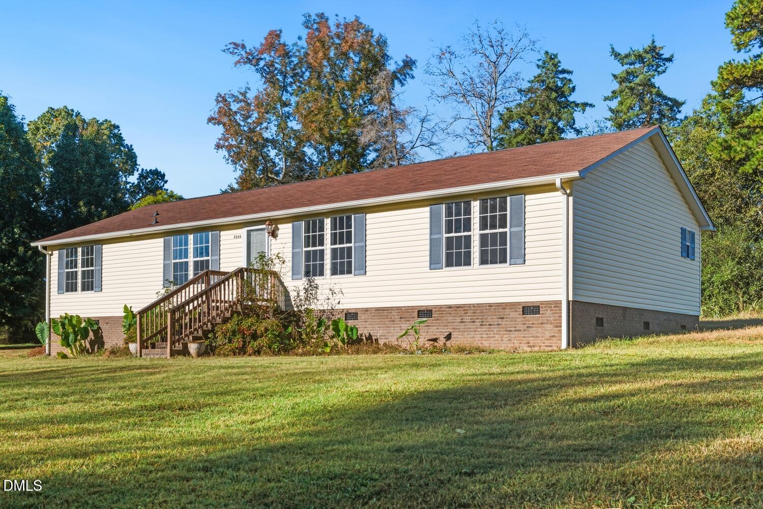 7555 Babe Ruth Trail Snow Camp, NC 27349 - Photo 29 of 38 a front view of a house with a garden