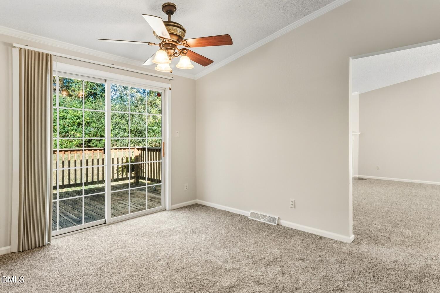 7555 Babe Ruth Trail Snow Camp, NC 27349 - Photo 6 of 38 an empty room with windows and a chandelier fan