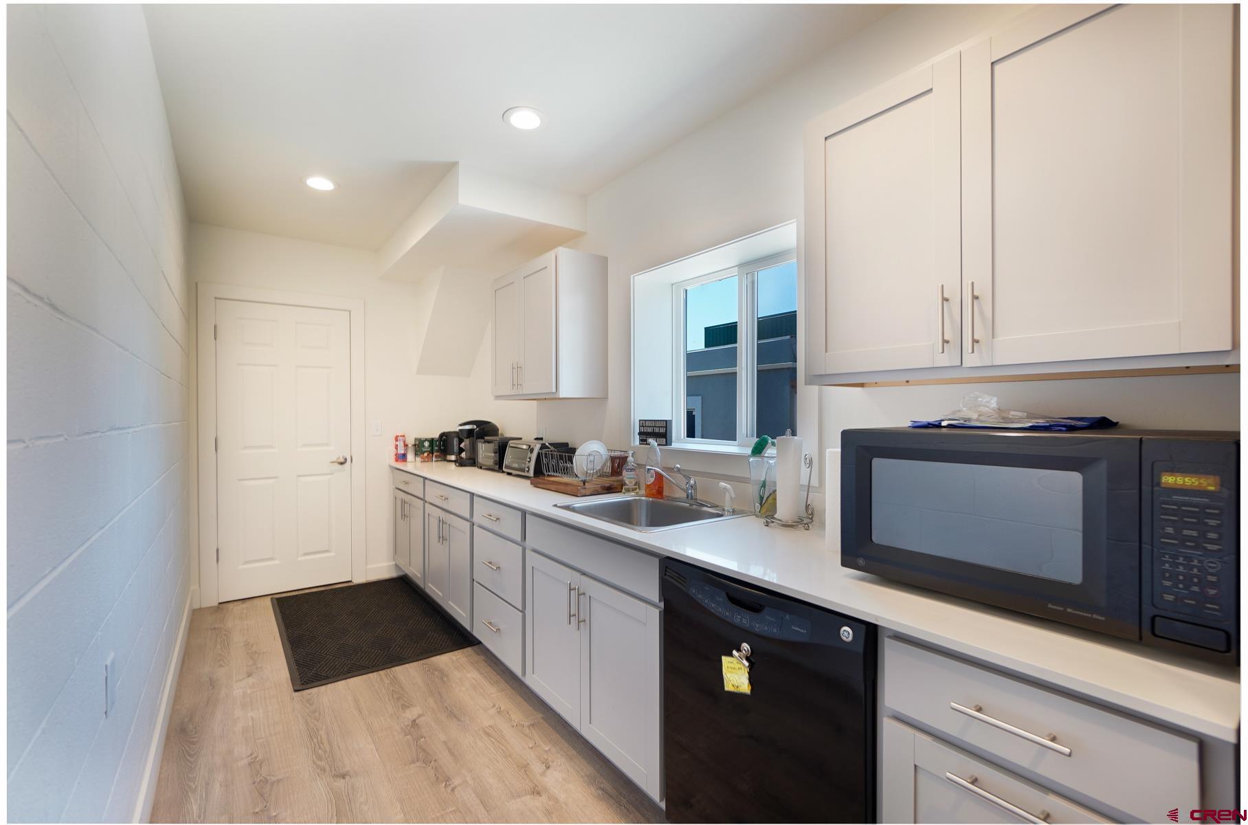 3067 Main Avenue Durango, CO 81301 - Photo 14 of 23 a kitchen with a sink stove and cabinets