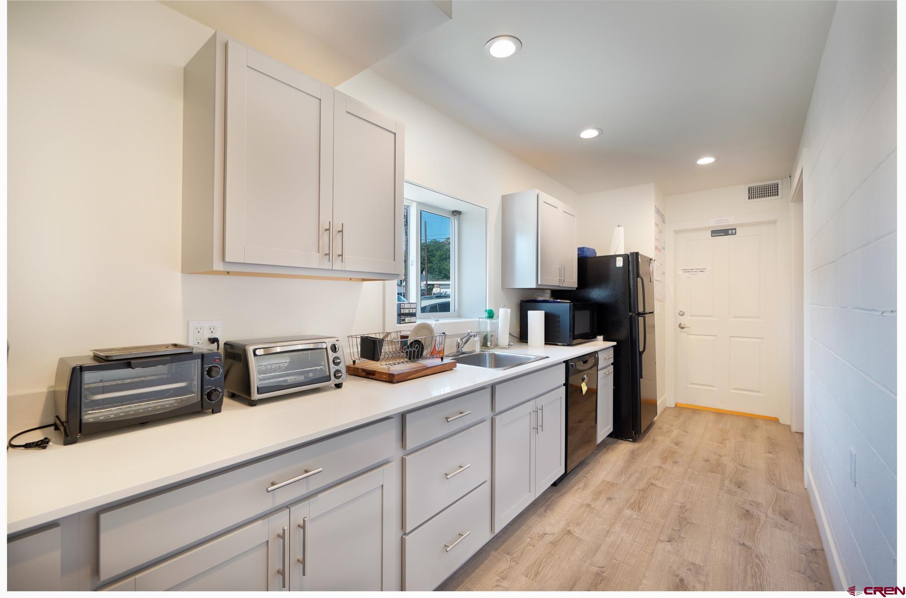 3067 Main Avenue Durango, CO 81301 - Photo 15 of 23 a kitchen with a sink dishwasher stove and refrigerator