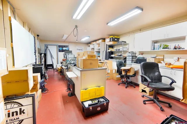 a bathroom with a toilet sink vanity and mirror