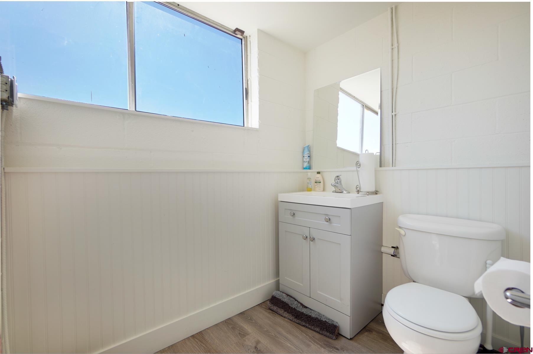 3067 Main Avenue Durango, CO 81301 - Photo 20 of 23 a bathroom with a toilet sink vanity and mirror