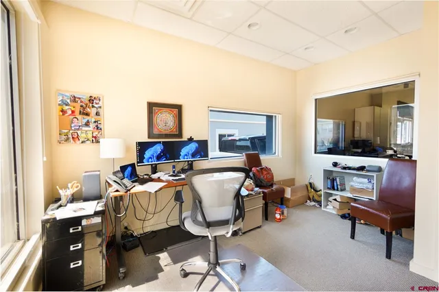 a bed room with furniture and a flat screen tv