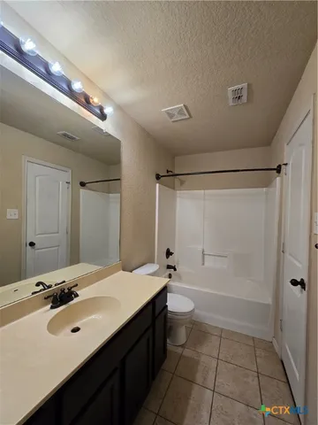a bathroom with a double vanity sink a mirror and a bathtub