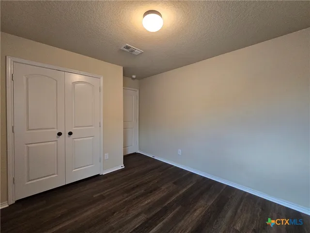 a view of room with wooden floor