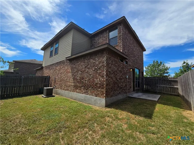 a view of a house with wooden fence