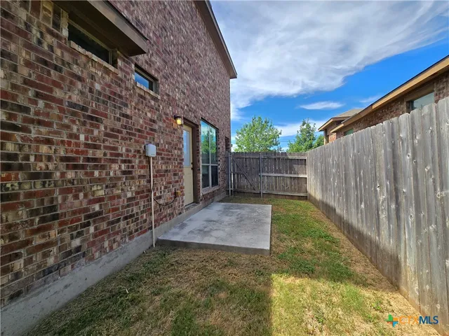 a view of yard with wooden fence