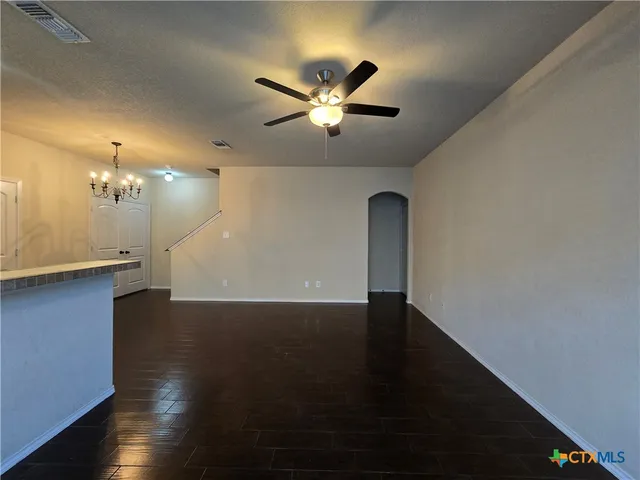 a view of a livingroom with a ceiling fan and wooden floor