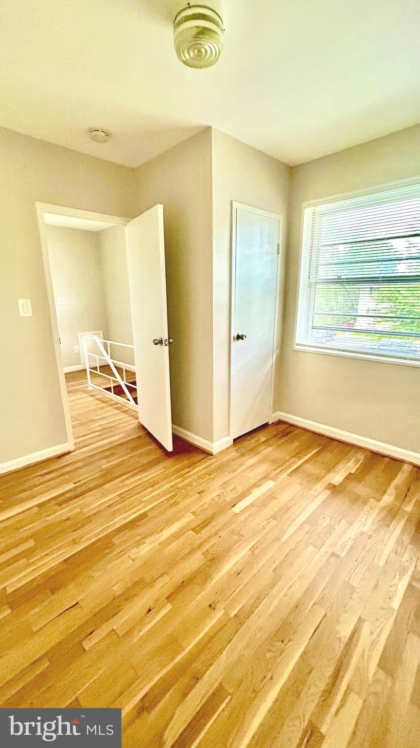 5319 Pooks Hill Road, Unit 1 Bethesda, MD 20814 - Photo 15 of 37 a view of a room with wooden floor and windows