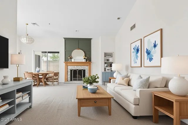 a living room with furniture a fireplace and a flat screen tv