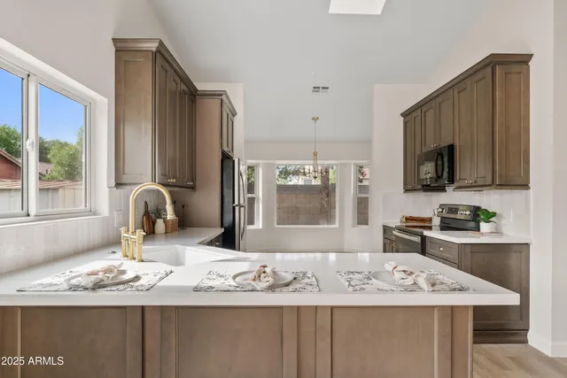 a kitchen with a sink stove and refrigerator