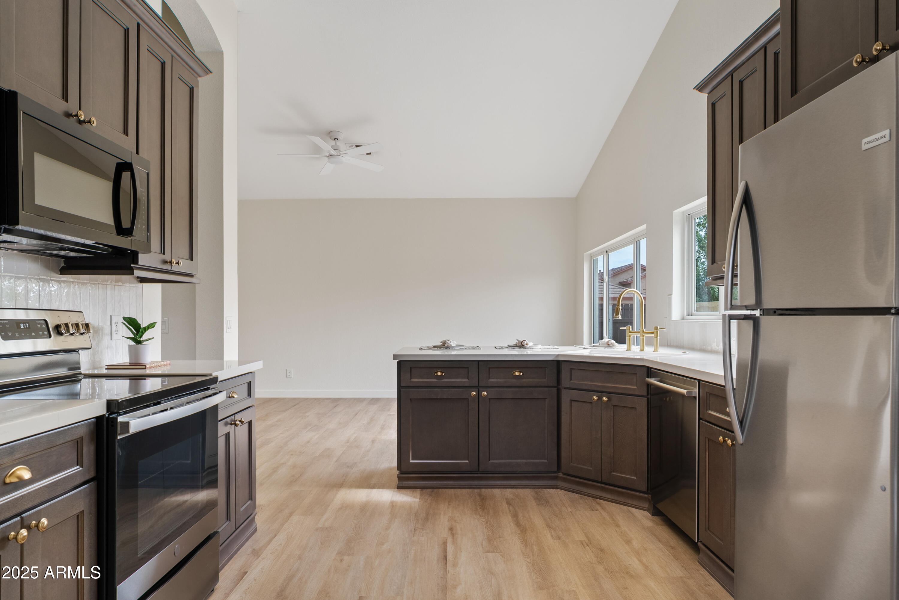 550 East Appaloosa Road Gilbert, AZ 85296 - Photo 14 of 41 a kitchen with stainless steel appliances granite countertop a refrigerator a stove top oven a sink and dishwasher