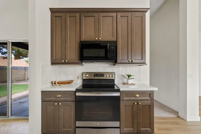 a kitchen with stainless steel appliances granite countertop a refrigerator a stove top oven a sink and dishwasher