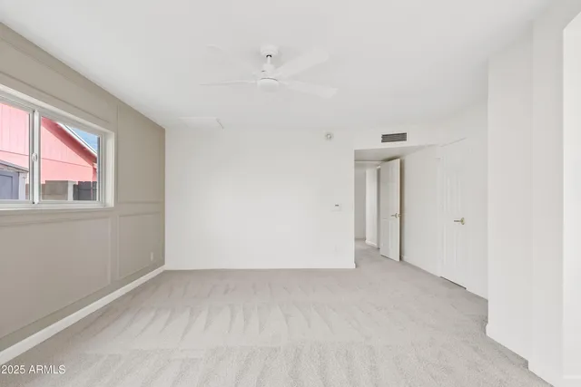 a bedroom with a bed a couch and dresser