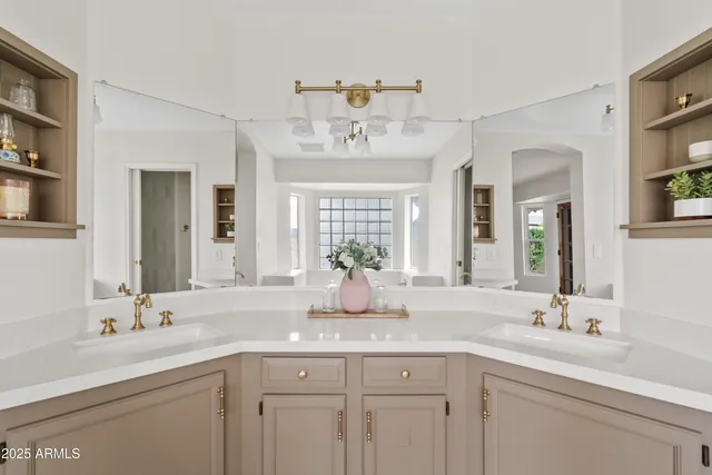 a spacious bathroom with a tub sink and mirror