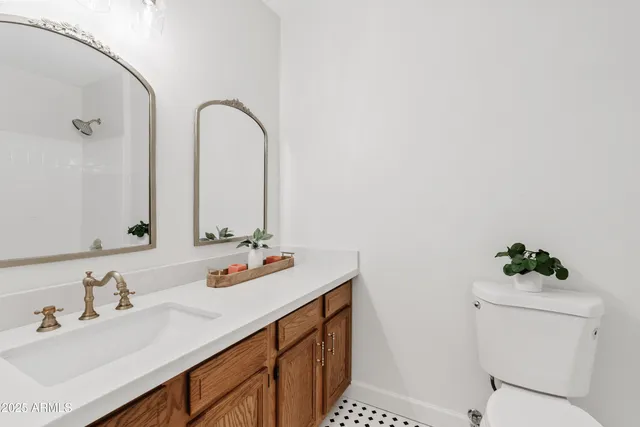 a bathroom with a sink vanity granite and toilet