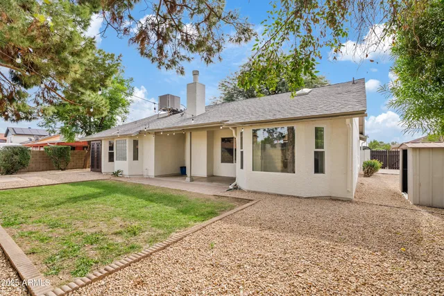 a front view of a house with a garden and yard