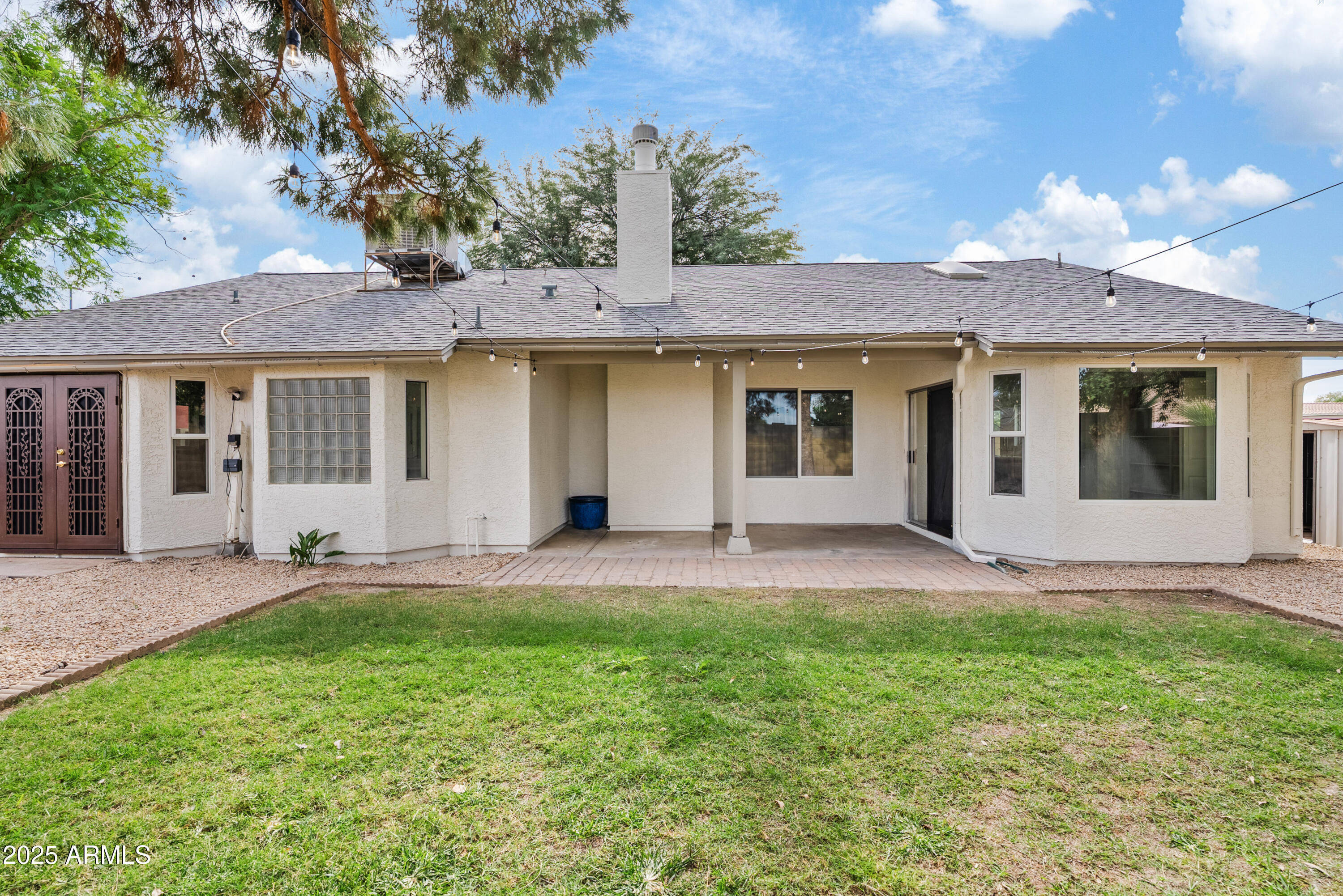 550 East Appaloosa Road Gilbert, AZ 85296 - Photo 37 of 41 a view of a house with a yard and large tree