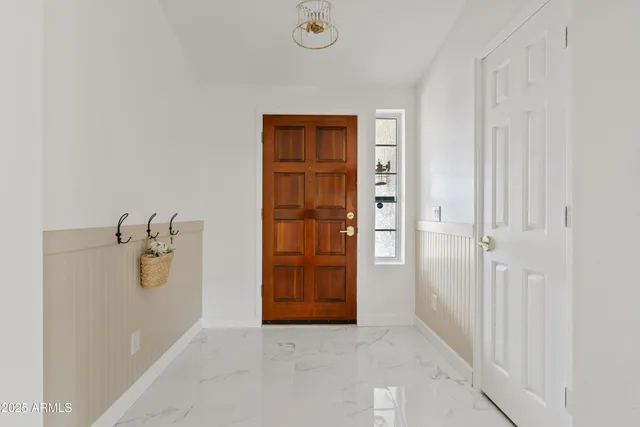 a white house with a tree in front of it