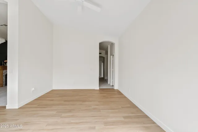 a view of a room with a windows and a ceiling fan