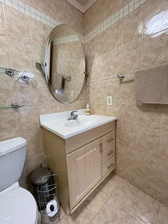 a bathroom with a sink toilet and mirror