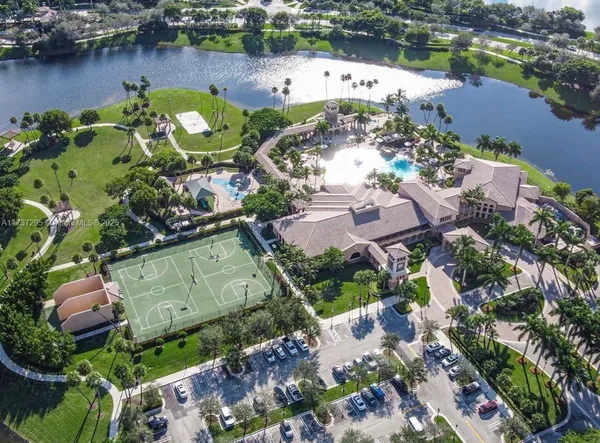 an aerial view of a house with a garden and lake view