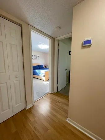 a view of a hallway with wooden floor