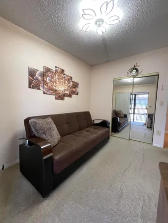 a living room with furniture and a chandelier
