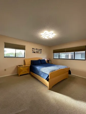 a bedroom with a bed and window