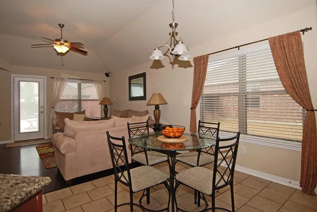 a view of a dining room with furniture and chandelier