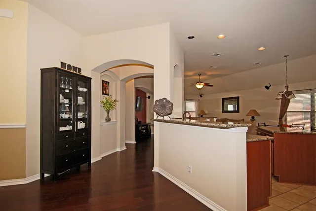 a kitchen with stainless steel appliances a refrigerator a stove a sink and a wooden floors