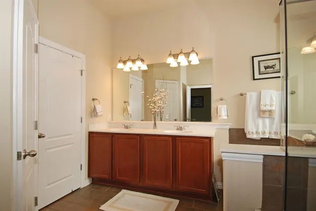 a spacious bathroom with a double vanity sink and a mirror